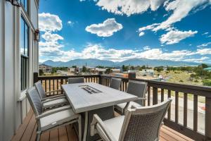 a patio with a table and chairs on a balcony at Whitewater Estate House & Guesthouse w Hot Tub in Buena Vista