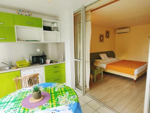 a small room with a bedroom with a bed and a mirror at Studio vue mer, pieds dans l'eau in Le Gosier +5 photos