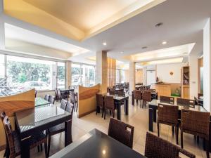 a restaurant with tables and chairs in a room at Travel Road Motel in Hualien City
