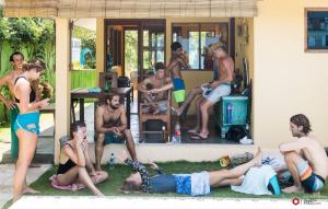 a group of people sitting on the grass at Blue Coco in Keramas