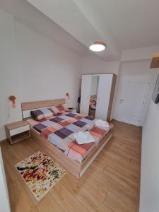 a bedroom with a large bed and a mirror at New apartment in Skopje Center - FREE Private Parking in Skopje +34 photos
