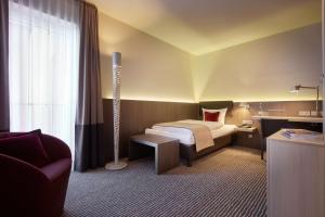 Voodi või voodid majutusasutuse bigBOX ALLGAEU Hotel toas