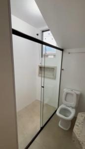 a small bathroom with a toilet in a room at Casa de Temporada Carrancas-MG in Carrancas