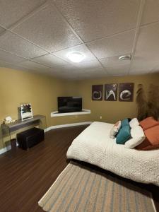 a bedroom with a bed and a tv on the wall at Suite Sunrise in Maclennan Township +7 photos