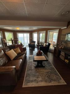 a living room with a couch and a coffee table at Suite Sunrise in Maclennan Township
