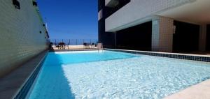 a swimming pool on the side of a building at Golden Tower - Flat a Beira Mar in Natal