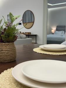 a living room with white plates on a table at Cove Chalet 1شاليه كوڤ in Al Ahsa +60 photos