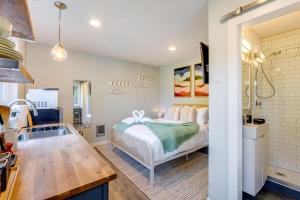 a bedroom with a bed and a kitchen with a sink at Perch - Ballard Cozy in Seattle