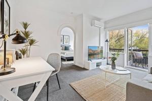 a white living room with a white table and chairs at Urban Oasis Prahran in Melbourne +20 photos