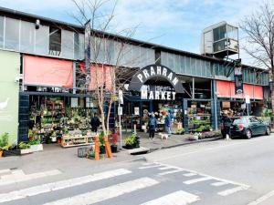 a market with people standing in front of a building at Urban Oasis Prahran in Melbourne