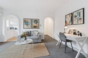 a living room with a couch and a table at Urban Oasis Prahran in Melbourne