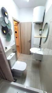 a bathroom with a toilet and a sink and a mirror at Relax A 3 in Zaboric