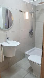 a bathroom with a sink and a toilet and a mirror at Relax A 3 in Zaboric +16 photos