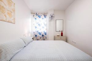 Łóżko lub łóżka w pokoju w obiekcie Amura Motril. Apartamento con garaje