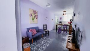 a living room with a blue couch and a table at Apart Pousada Villa das Flores in Penha