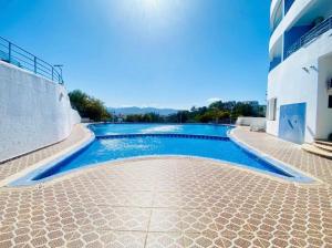 a swimming pool in the middle of a building at Cabo Dream a Cabo Negro in Cabo Negro