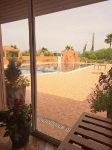 a sliding glass door with a view of a patio at La Villa Olive in Riaïna +4 photos