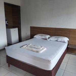 a bed with two pillows on top of it at Rancho das Montanhas in Muniz Freire +38 photos
