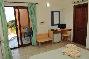 Postel nebo postele na pokoji v ubytování Hotel Castello Budoni