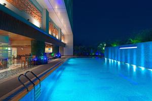 a swimming pool in a hotel at night at The Westin Dhaka in Dhaka