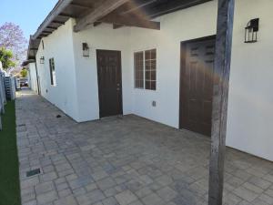 a patio with two doors on a building at Xlnc Exotic Home Lemon Groove in Lemon Grove