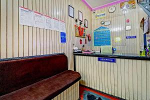 a restaurant with a bar and a bench in a room at SPOT ON Sahara lodge in Bengaluru +32 photos