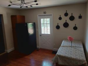 a kitchen with a table and a refrigerator and a door at 5BR Home Pool, hot tub, pet friendly by ARK Experience in Williamstown
