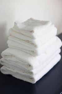 a stack of white towels sitting on a table at American Hotel in Los Angeles
