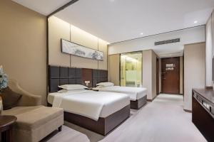 A bed or beds in a room at 宜昌虹桥国际大酒店