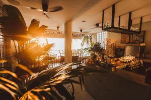 a living room with a table and some plants at Frangipani El Nido in El Nido