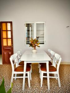 a white table and chairs with a plant on it at Anna homestay- Đông Tác, Tuy Hoà, Phú Yên in Ðông Tác (1)
