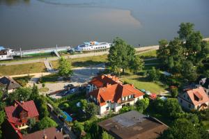 an aerial view of a house in a village with a body of water at Austeria Kazimierska in Kazimierz Dolny