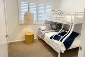 a bedroom with a bunk bed and a window at Brand new 4 bedroom home with Golf Views in Yarrawonga +29 photos