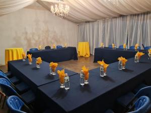 a table in a tent with blue tables and chairs at Sky Beach Hotel in Hopewell