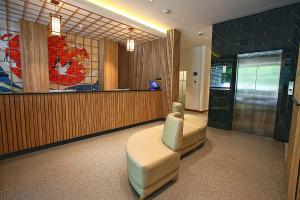 a waiting room with a chair and a counter at Mimaru Hotel Jakarta in Jakarta