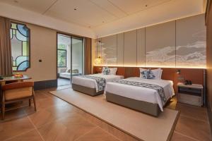 Voodi või voodid majutusasutuse Guangdong Hot Spring Hotel toas