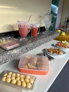 a counter with some food and some drinks on it at Pousada BG Lençóis in Barreirinhas +25 photos