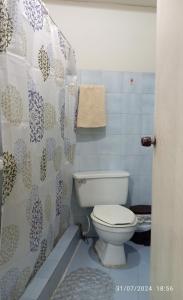 a bathroom with a white toilet in a room at Hostal Camino Salinero in Zipaquirá