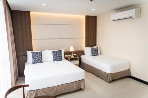 Postel nebo postele na pokoji v ubytování DCCCO Hotel