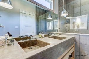 a large sink in a bathroom with a large mirror at The Shotgun House from Fixer Upper - 800 5-Stars - Steps to Silos, BU, & Downtown in Waco +25 photos