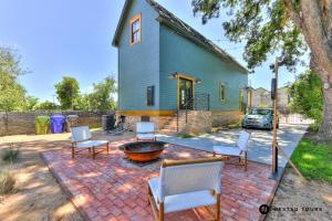 a group of chairs and a fire pit in front of a house at The Shotgun House from Fixer Upper - 800 5-Stars - Steps to Silos, BU, & Downtown in Waco