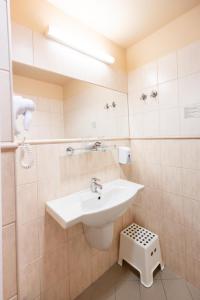 a bathroom with a sink and a mirror at Hotel Estella Superior in Eger