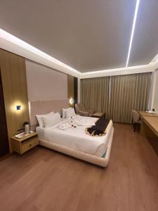 a hotel room with a large bed and a desk at Hotel Oxina Cizel in Kodaikānāl +21 photos