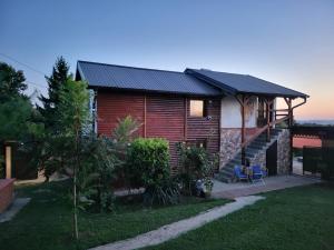 a log house with a solarium on the side of it at VIKENDICA GARFILD SA BAZENOM i SAUNOM BANJA LUKA in Banja Luka