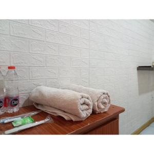 a towel sitting on a table in a bathroom at RedDoorz at Luxury Homestay near Aloha Waru Surabaya in Sidoarjo