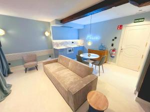 a living room with a couch and a table at Lemon Suites Santander in Santander
