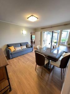 a living room with a blue couch and a table at Hilltop Farm house Party house in Ardmore College +24 photos