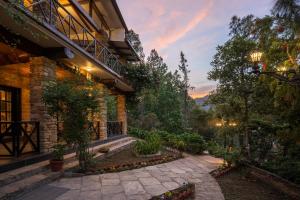 a house with a stone walkway in front at Buransh Terraces Luxury 3&4BHK Villas with Mountain View & Caretaker & Kitchen & Complementary Breakfast in Bhowāli