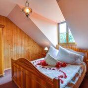 Un dormitorio con una cama de madera con flores. en Ranč Kostelany, en Kroměříž