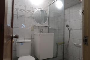 a bathroom with a toilet with a mirror and a shower at 明月Agetsu in Chiayi City +46 photos